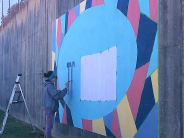 Artist Alison Hamil working on the #BrookhavenStrong mural along Peachtree Road.