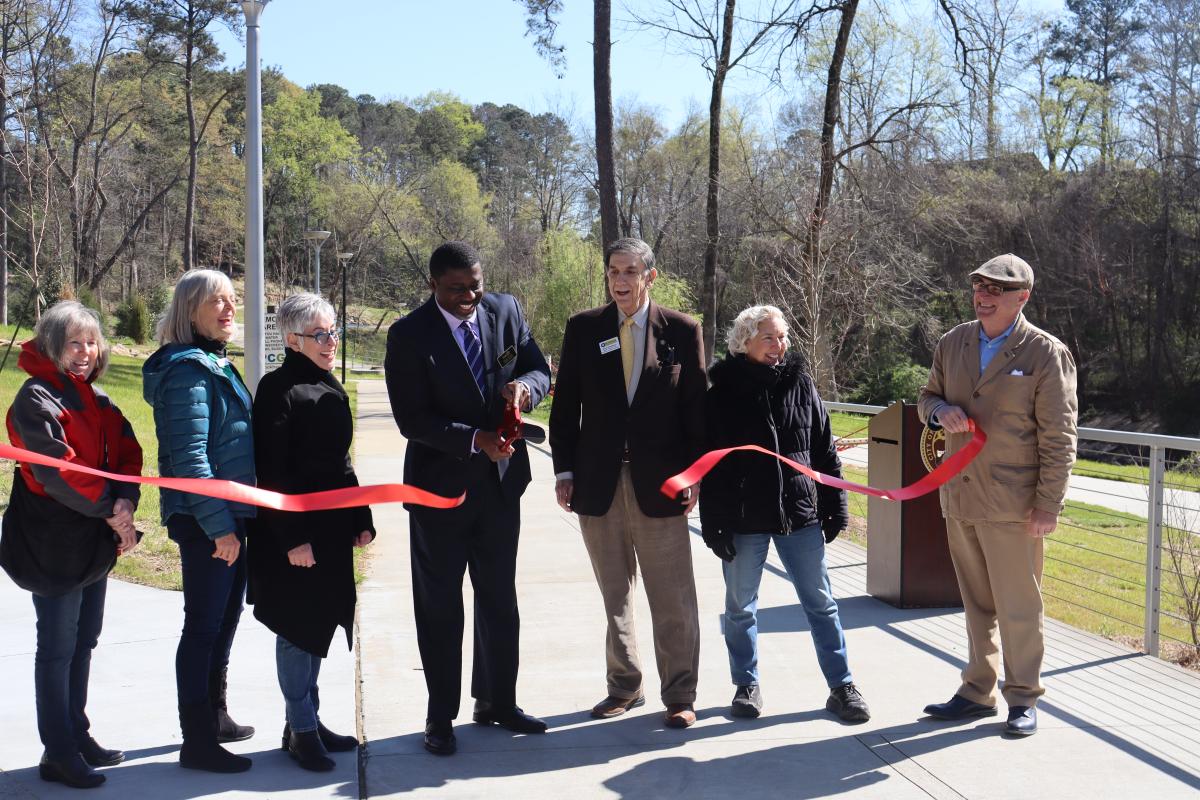 District 4 Councilman John Funny cuts the ribbon with members of PCG, Inc and the Brookhaven Chamber of Commerce
